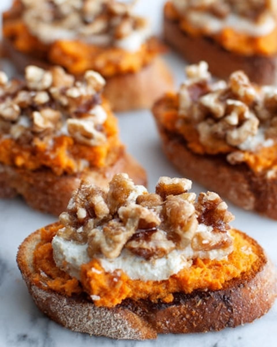 The image shows several small toasted bread slices on a white marbled surface, each topped with a thick layer of orange sweet potato mash. On top of the sweet potato layer, there is a creamy white spread, and the final layer consists of chopped nuts, mainly walnuts, scattered generously over the top. The bread's crust is slightly browned and crispy, contrasting with the soft and colorful toppings. Photo taken with an iphone --ar 4:5 --v 7