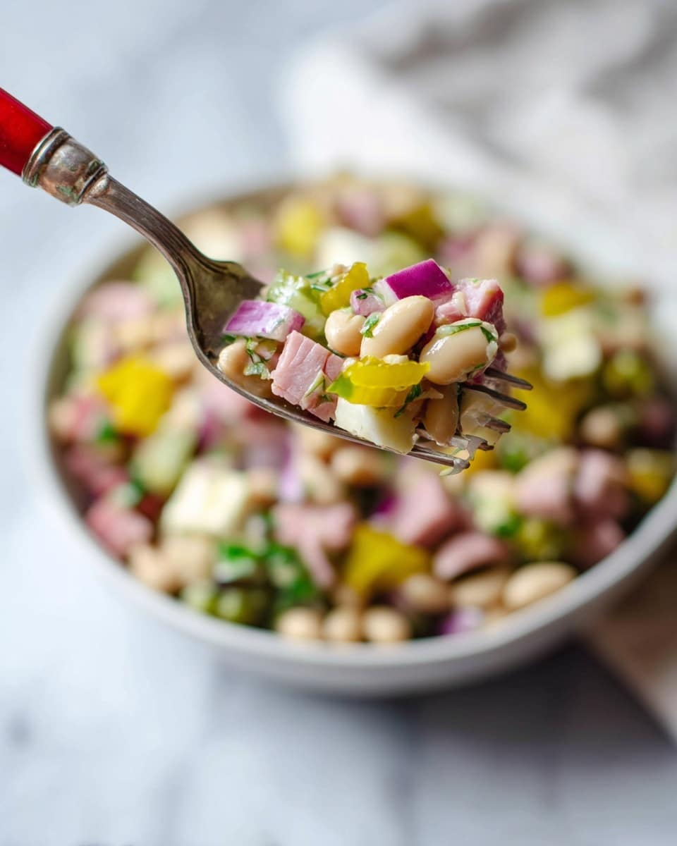 A close-up of a silver fork with a red handle holding a small bite of mixed salad above a white bowl filled with the same salad, sitting on a white marbled surface. The salad has about five visible layers, including pale beige beans as the base, small cubes of pink ham, white cheese chunks, bright yellow pickled pepper slices, and chopped green herbs and red onion mixed throughout, giving a colorful and fresh look. In the background, the bowl shows the salad layers blurred but still colorful and textured. photo taken with an iphone --ar 4:5 --v 7