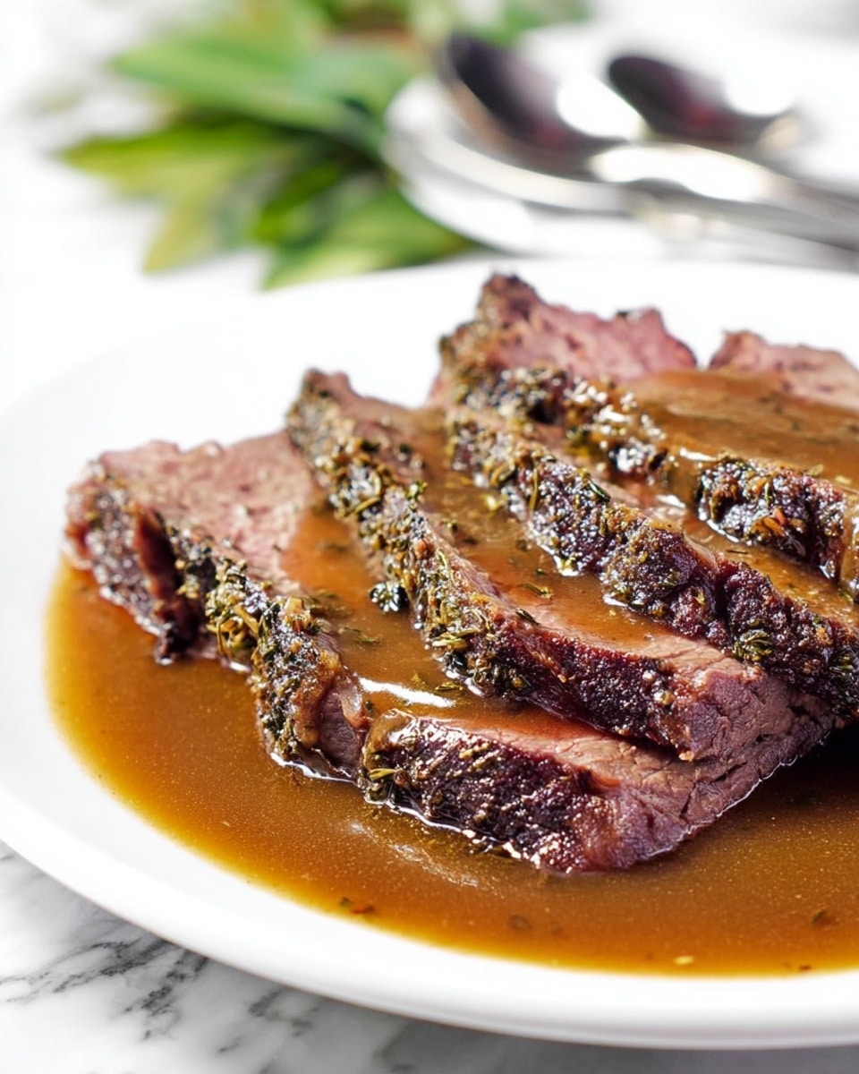 A close-up of a silver fork holding a small piece of cooked meat covered in glossy brown sauce with visible herbs. The meat is juicy with some charred edges, and the sauce adds a shiny texture, making it look tender and flavorful. In the blurred background, there are more pieces of the same meat on a white plate, resting on a white marbled surface with some green garnish slightly visible. Photo taken with an iphone --ar 4:5 --v 7
