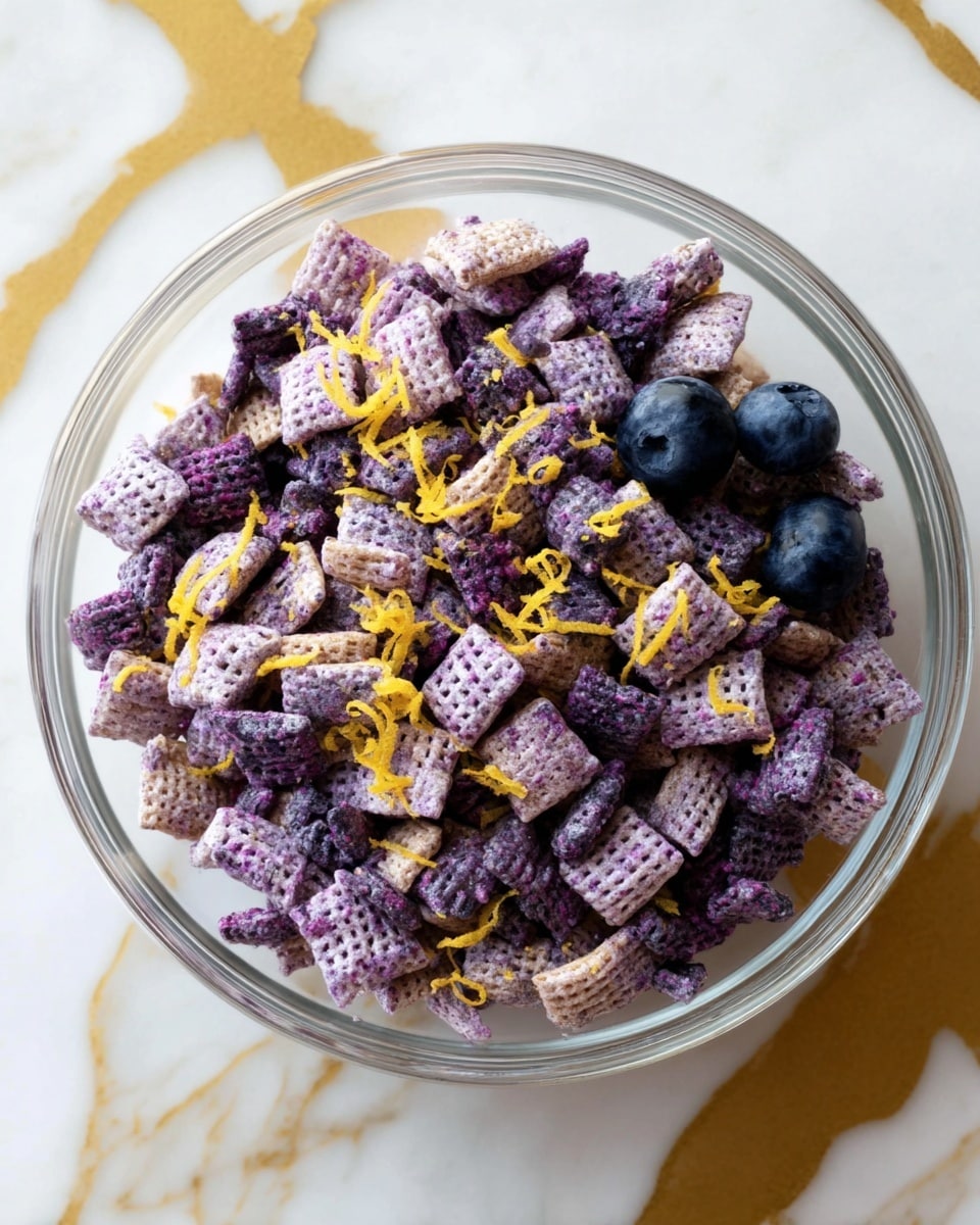 A clear glass bowl filled with light purple chex cereal pieces mixed with dark purple crushed cereal bits, topped with small bright yellow zest strips scattered over the top. Two whole blueberries sit at the bottom right inside the bowl. The bowl rests on a white marbled surface with gold veins. Photo taken with an iphone --ar 4:5 --v 7