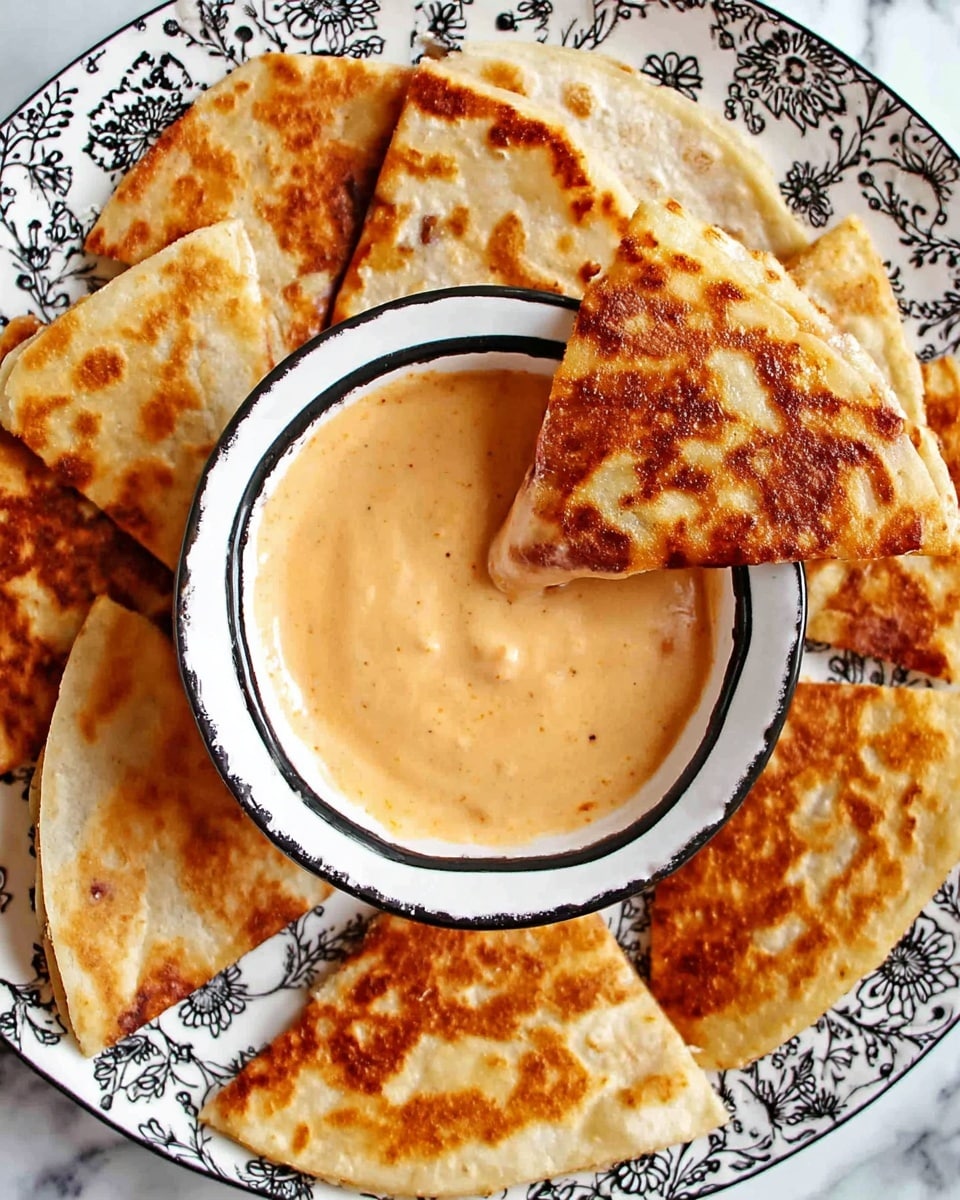 The image shows several golden-brown, crispy quesadilla slices arranged in a circle on a white plate with black floral designs. In the center, there is a small white bowl with a black rim filled with a creamy, light orange dipping sauce. One quesadilla slice is lifted above the bowl, partially dipped in the sauce, revealing its soft texture with browned spots. The whole scene is set against a white marbled textured surface, enhancing the warm colors of the quesadillas and sauce. photo taken with an iphone --ar 4:5 --v 7